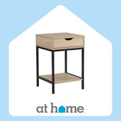 a small wooden table with a drawer on the bottom and an at home logo above it