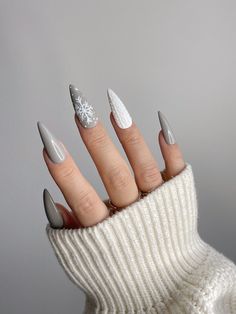 "✨Grey Snowy Nail Set ✨ \"Lumi\"  💫 Origin: Finnish 💫 Meaning: \"Snow\" *Stiletto Medium is displayed in the photos* All sets are made to order and I will make sure orders are shipped out as soon as possible. Although, I am one person and all nail sets are designed and made by me, so I do apologize if there are any delays or slow processing on my end. Every nail set is carefully hand painted and thoughtfully hand designed. While I only use high quality materials, I make sure every nail set is prepped with a builder gel layer underneath to ensure durability.    I would highly recommend measuring your nails before purchasing to ensure that you have the correct sizes for your nails. Please add your personalized nail sizes in the Personalization section if the set sizes do not match to your Grey Nails Winter, Winter Nails Grey And White, December Stiletto Nails, Christmas Grey Nails, White Snowy Nails, Grey Xmas Nails, Grey And White Christmas Nails, Cute Winter Nails Almond, Winter Silver Nails