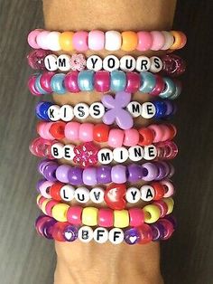 several bracelets with words on them that say i'm yours kiss me be mine