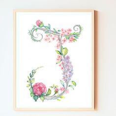 the letter c is made up of watercolor flowers and vines on white paper with a wooden frame