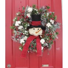 a snowman wreath on a red door