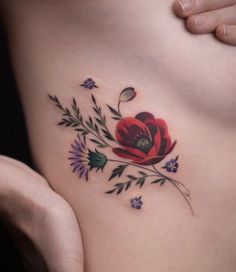 a woman's stomach with flowers and leaves on it