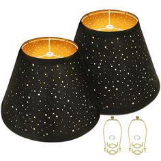 two black lamps are next to each other with gold trimmings and white dots on them