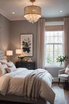 a bedroom with gray walls, white bedding and a chandelier hanging from the ceiling