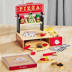 there is a pizza stand with different items on the table and in front of it