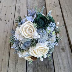 a bouquet of flowers sitting on top of a wooden floor