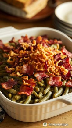 a casserole dish filled with green beans and bacon