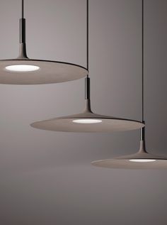 three lights hanging from the ceiling in a room