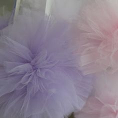 two fluffy pink and purple pom poms