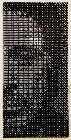 a black and white photo of a man's face made out of small dots