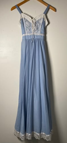 This 1970's Gunne Sax dress is absolutely gorgeous! In a child size 3, it is in excellent condition! Here are the exact measurements for this sleeveless Gunne Sax gown: Strap Length: 4 1/2 inches Shoulders: 10 1/2 inches Chest: 26 inches Waist: 20 inches Hips: 28 inches Shoulders to Hem: 50 inches Sweep: 58 inches This dress is a beautiful, powder blue and has lace trim around the bodice and hem. The front is a lace up style with a cotton cord tie. It zips up the back and has a tie at the waist Sax Dress, Gunne Sax Dress, 70s Dress, Lovely Dresses, Cotton Cord, Powder Blue, Blue Lace, Pretty Dresses