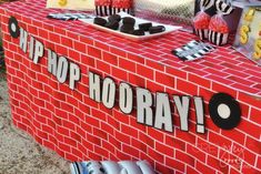 a red brick table with black and white decorations on it that says hip hop hooray