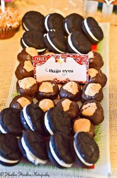 a table topped with lots of chocolate covered cookies