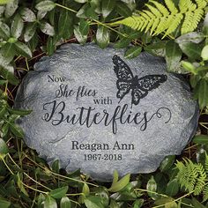 a stone with the words, now she flies with butterflies on it