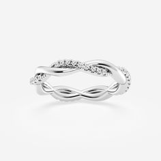 a white gold ring with diamonds on the sides and an intertwined design in the middle