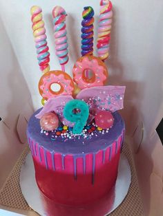 a birthday cake decorated with donuts and sprinkles