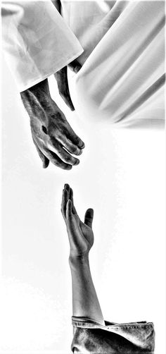 two hands reaching for each other in front of a white background with black and white image