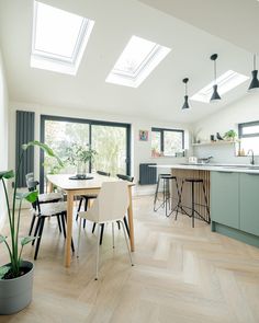 an open kitchen and dining room with skylights