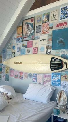 a surfboard mounted to the side of a wall above a bed in a bedroom