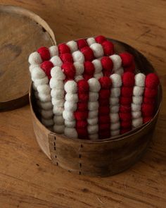 an american flag made out of red and white wool in a wooden box on a table