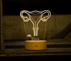 a light that is shaped like a utensil with the word dr rocco on it