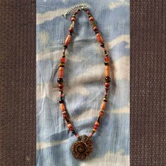 Handmade Ammonite Fossil Necklace With Carnelian, Tiger Eye, Petrified Wood, Wooden Beads, Vintage Wooden Beads, And Vintage Coral (*I Usually Stay Away From Coral, As I Feel It's Obtained Unethically, But This Is From The 1970s). Ammonites Were Marine Creatures Similar To The Nautilus That Lived During The Jurassic And Cretaceous Periods. I Make These To Be Swimmable; However, Wooden Beads May Fade Over Time. Fossil Necklace, Marine Creatures, The Nautilus, Ammonite Fossil, Petrified Wood, Nautilus, Red Brown, Wooden Beads, Tiger Eye