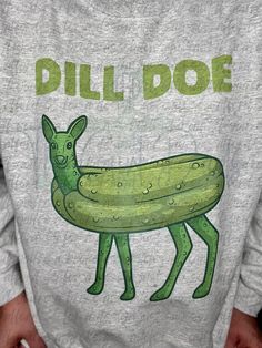 a person wearing a sweatshirt with a pickle on it's back and the words dill - doe written in green