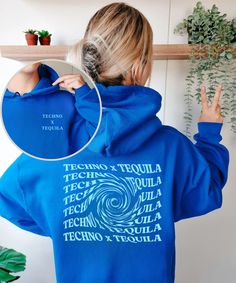 a woman wearing a blue hoodie with the words tech and tequila printed on it