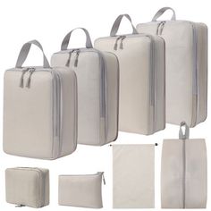 four pieces of white luggage with zippers on each side and two bags in the middle