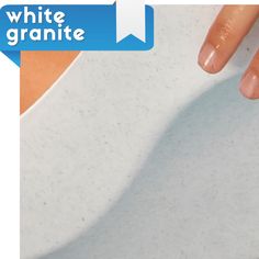 a woman's hand on top of a white counter