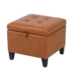 a brown leather ottoman sitting on top of a wooden table