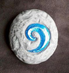 a white and blue swirl painted on a rock