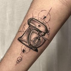 a tattoo on the arm of a person holding a blender