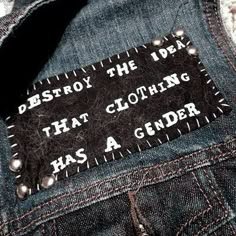 a patch that says destroy the idea that clothing has a genderer on it's back