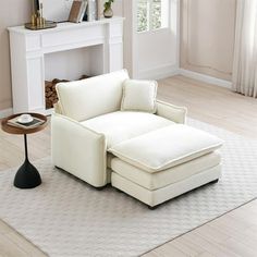 a white chair sitting on top of a rug in a living room