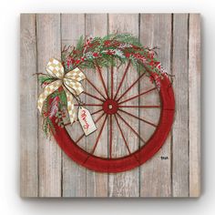 a bicycle wheel with a wreath on it hanging from the side of a wooden fence