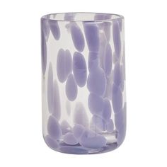 a glass filled with lots of purple rocks