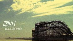 a roller coaster with the words crozet on it in front of a cloudy sky