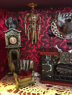 a room with red and gold wallpaper, ornate furniture and clocks