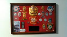 a red framed display with badges on it