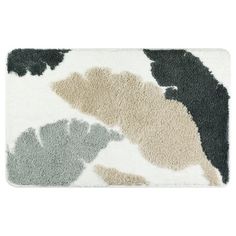 a bath mat with different colors and shapes on the front, including black, grey, white