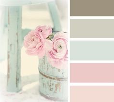 some pink flowers are in a bucket on a table with color swatches for the background