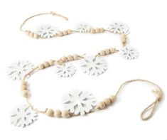 a white necklace and bracelet with snowflakes on the beads, along with a string