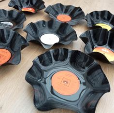 nine black bowls with orange labels on them