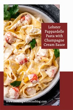 lobster papparella pasta with champagne cream sauce in a white bowl on a red and black plate