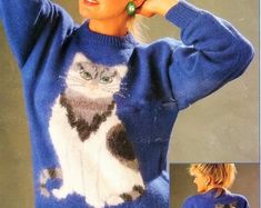 a woman wearing a sweater with a cat on it