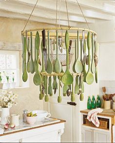 green spoons hanging from a chandelier in a kitchen