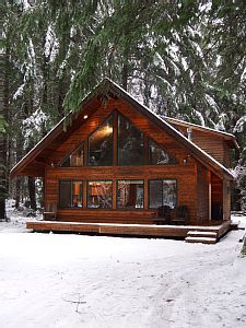 a cabin in the woods with snow on the ground