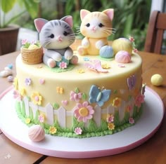 there is a cake with two cats on it