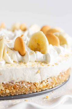 a close up of a cake with bananas on top and whipped cream around the edges